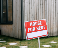 House for rent sign in front of a house